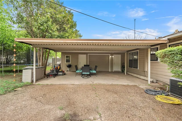 a view of a house with backyard porch and furniture