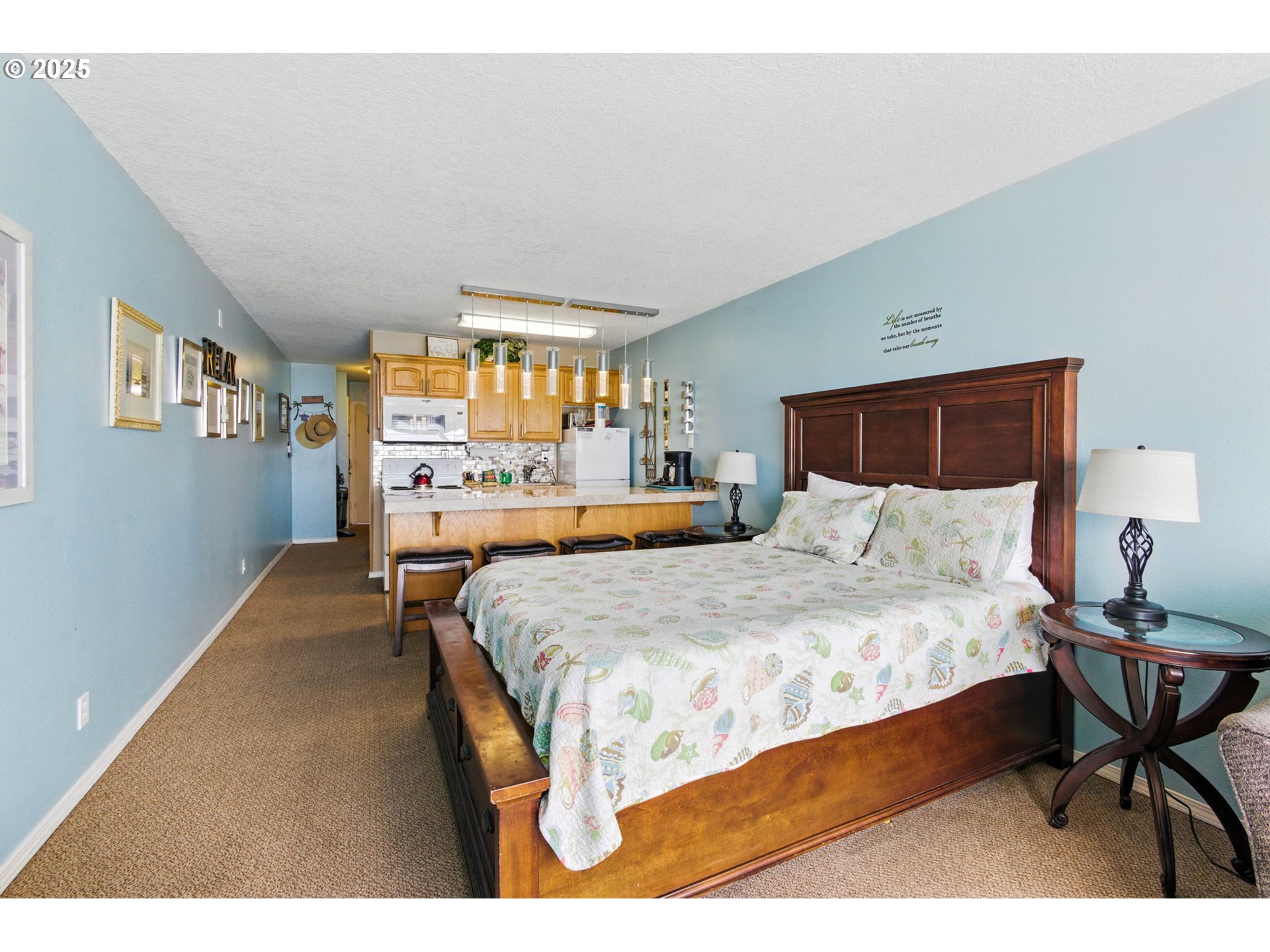 145 Northwest Inlet Avenue, Unit 217 Lincoln City, OR 97367 - Photo 12 of 28 a bedroom with a bed mirror table and window