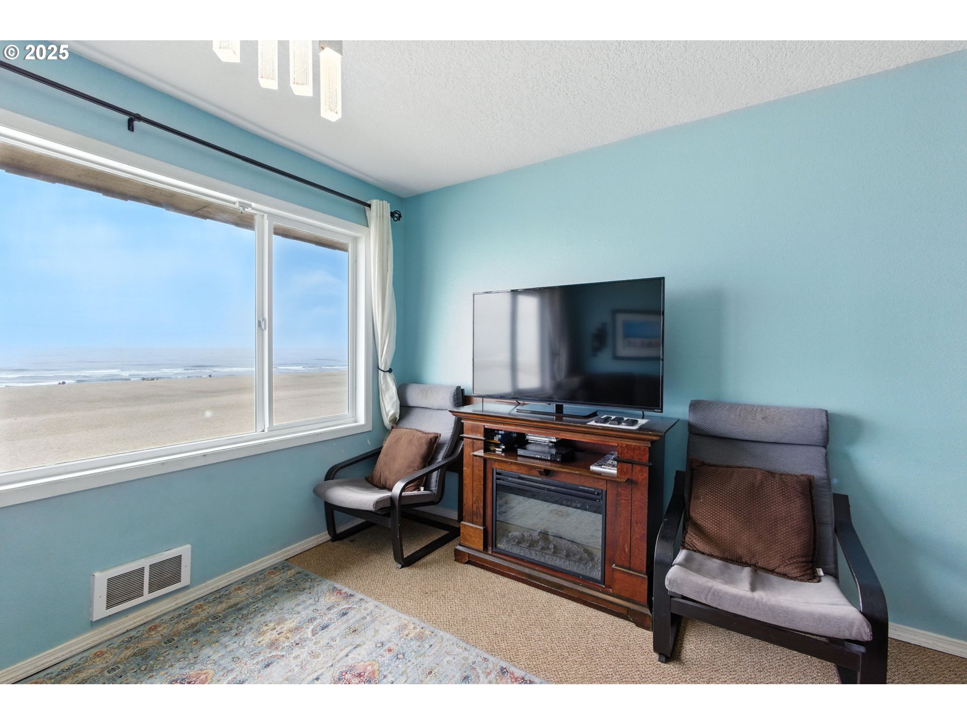 145 Northwest Inlet Avenue, Unit 217 Lincoln City, OR 97367 - Photo 13 of 28 a living room with furniture and a flat screen tv