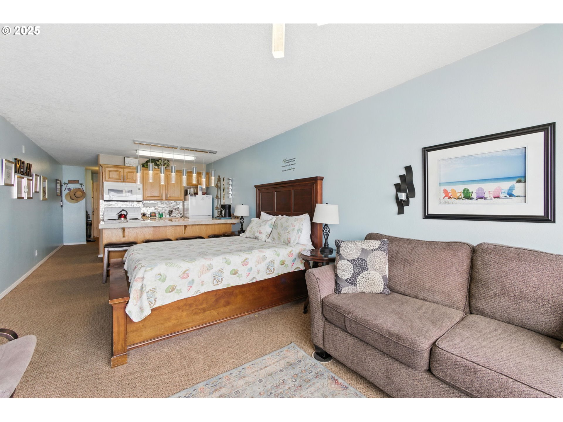 145 Northwest Inlet Avenue, Unit 217 Lincoln City, OR 97367 - Photo 14 of 28 a bedroom with a bed couch and window