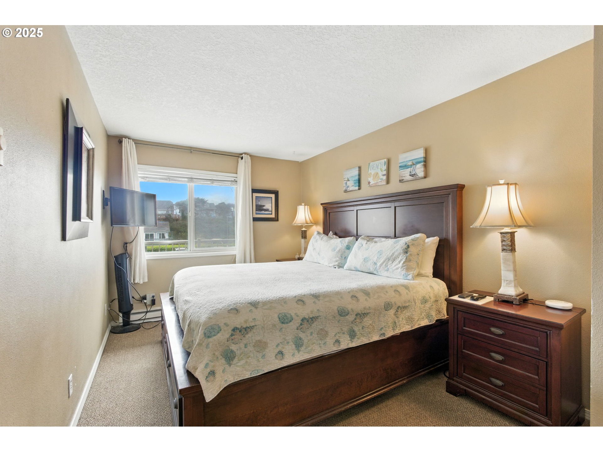 145 Northwest Inlet Avenue, Unit 217 Lincoln City, OR 97367 - Photo 17 of 28 a bedroom with a bed window and a night stand
