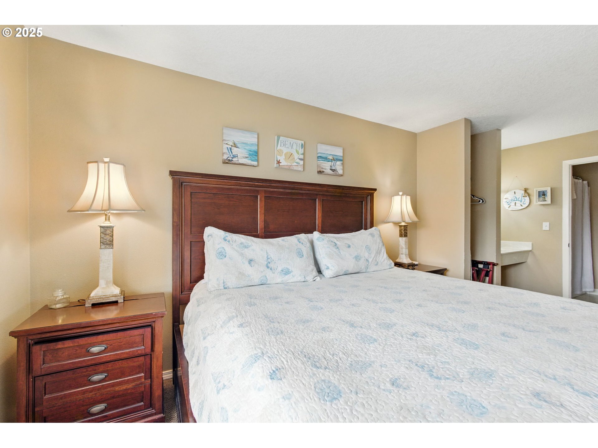 145 Northwest Inlet Avenue, Unit 217 Lincoln City, OR 97367 - Photo 19 of 28 a bedroom with a bed and a night stand