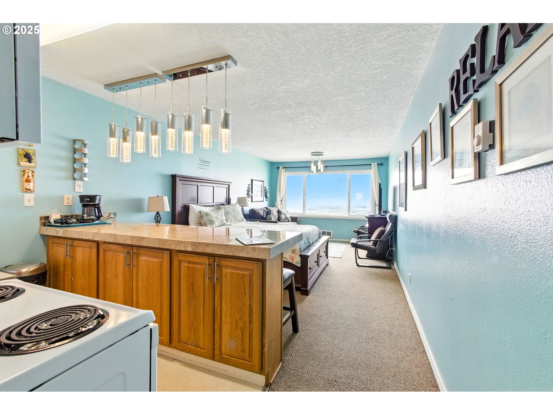145 Northwest Inlet Avenue, Unit 217 Lincoln City, OR 97367 - Photo 4 of 28 a kitchen with stainless steel appliances granite countertop a stove a sink dishwasher and cabinets with wooden floor
