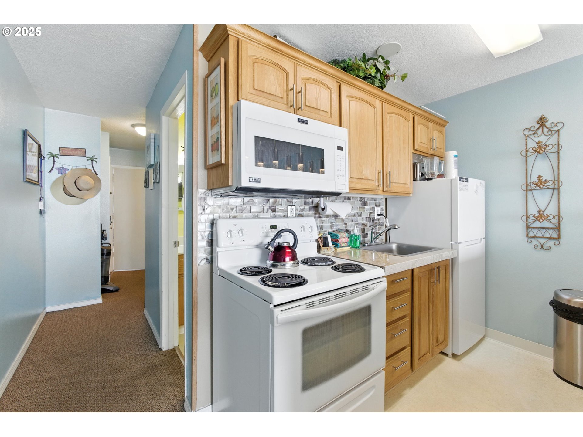 145 Northwest Inlet Avenue, Unit 217 Lincoln City, OR 97367 - Photo 5 of 28 a kitchen with a sink stove and refrigerator