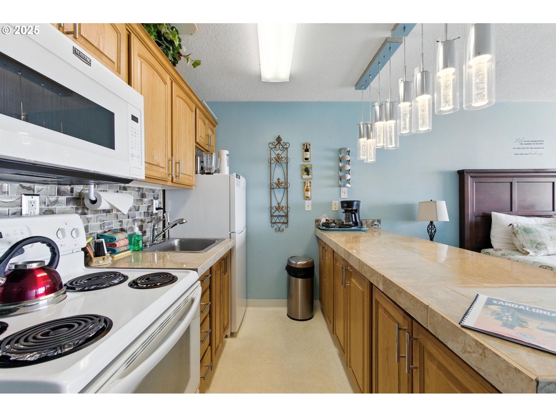 145 Northwest Inlet Avenue, Unit 217 Lincoln City, OR 97367 - Photo 6 of 28 a kitchen that has a sink a stove and a wooden floors