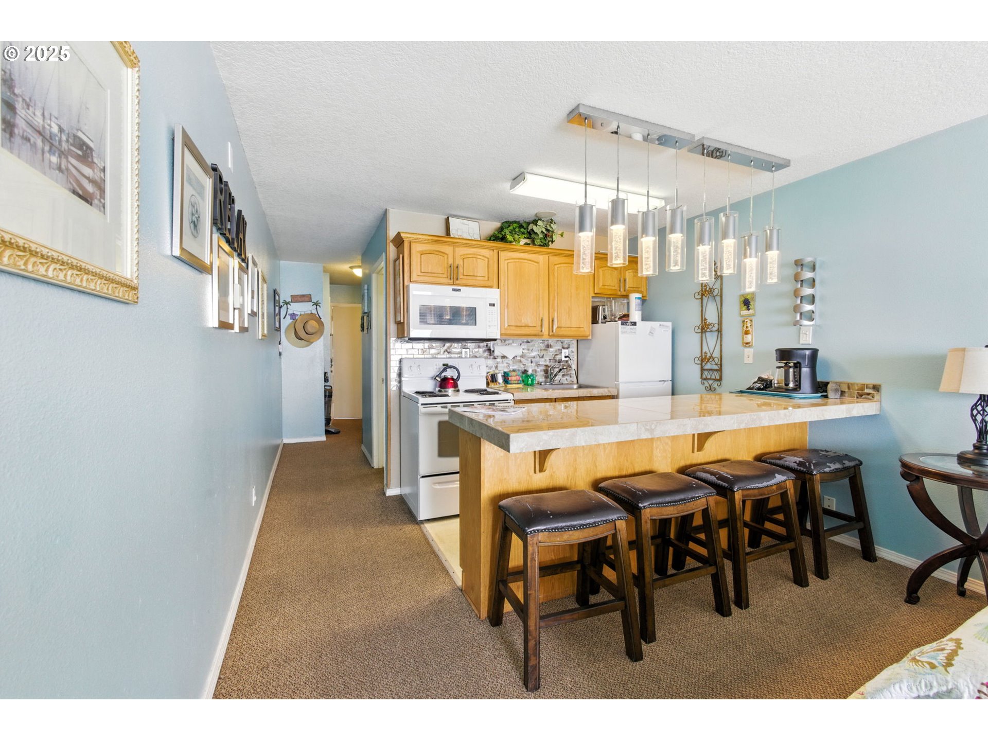145 Northwest Inlet Avenue, Unit 217 Lincoln City, OR 97367 - Photo 10 of 28 a dining hall with stainless steel appliances kitchen island granite countertop furniture and a view of kitchen