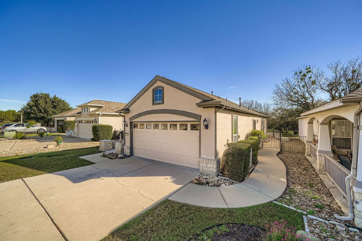 307 Mill Pond Path Georgetown, TX 78633 - Photo 2 of 26 View of front of property with stucco siding, driveway, and a gate
