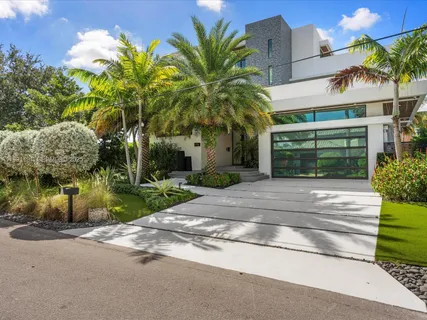 a couple of palm trees in front of house