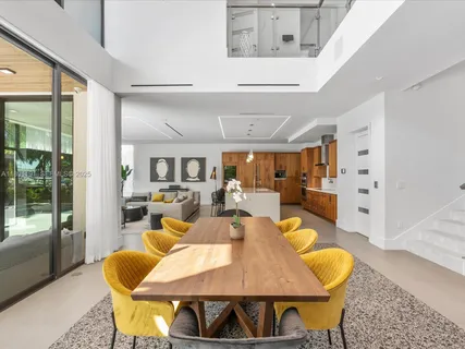 a large kitchen with stainless steel appliances a sink and large cabinets