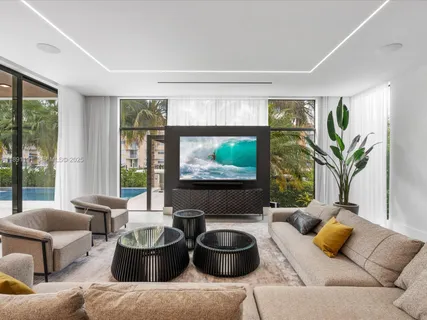 a living room with furniture and a floor to ceiling window