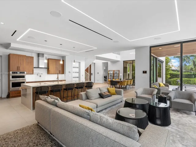 a living room with furniture and a floor to ceiling window