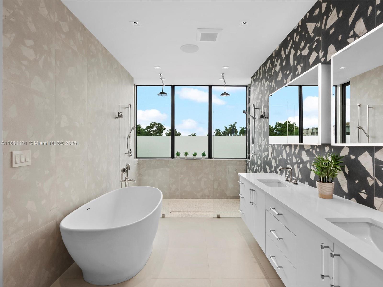 1736 Southeast 14th Street Fort Lauderdale, FL 33316 - Photo 26 of 54 a spacious bathroom with a double vanity sink a mirror and a bathtub