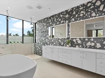 a bedroom with a bed and large windows