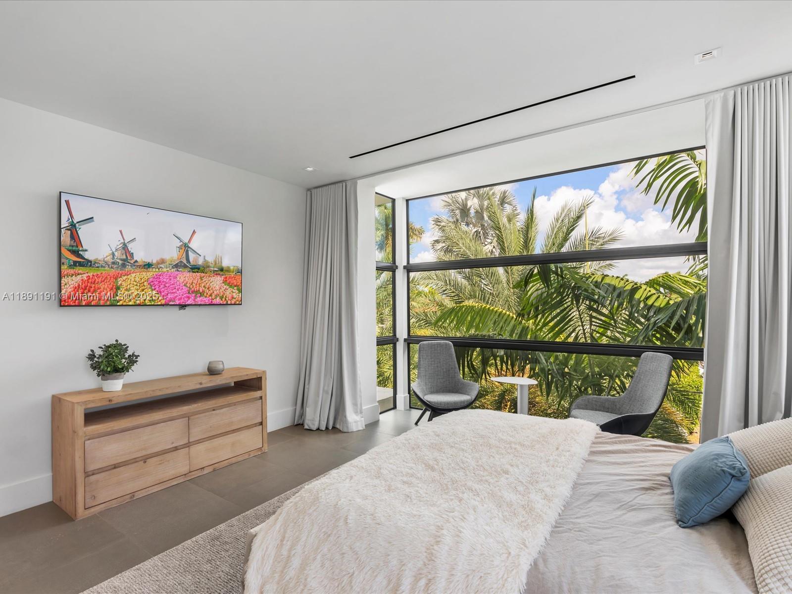 1736 Southeast 14th Street Fort Lauderdale, FL 33316 - Photo 31 of 54 a bedroom with a bed painting on wall and a large window