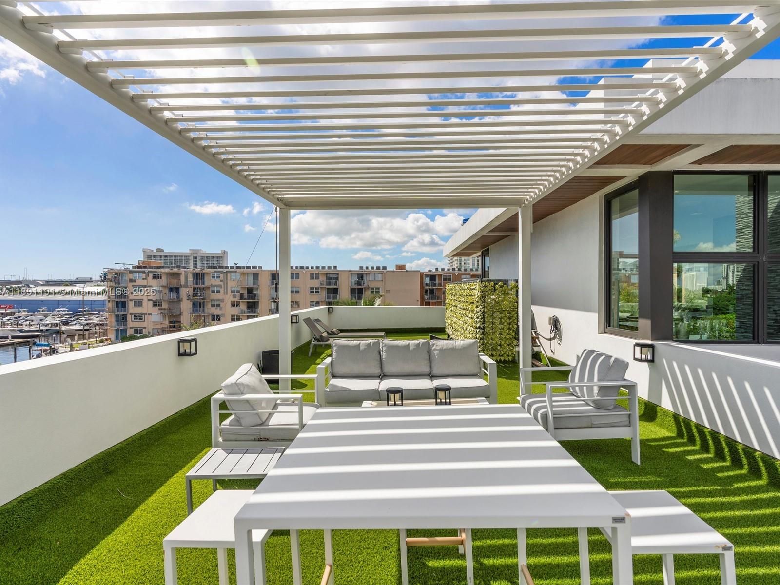 1736 Southeast 14th Street Fort Lauderdale, FL 33316 - Photo 40 of 54 a view of a patio with couches table and chairs with wooden floor and fence
