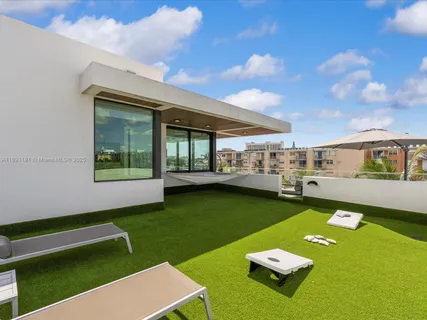 a view of swimming pool with outdoor seating and a potted plant