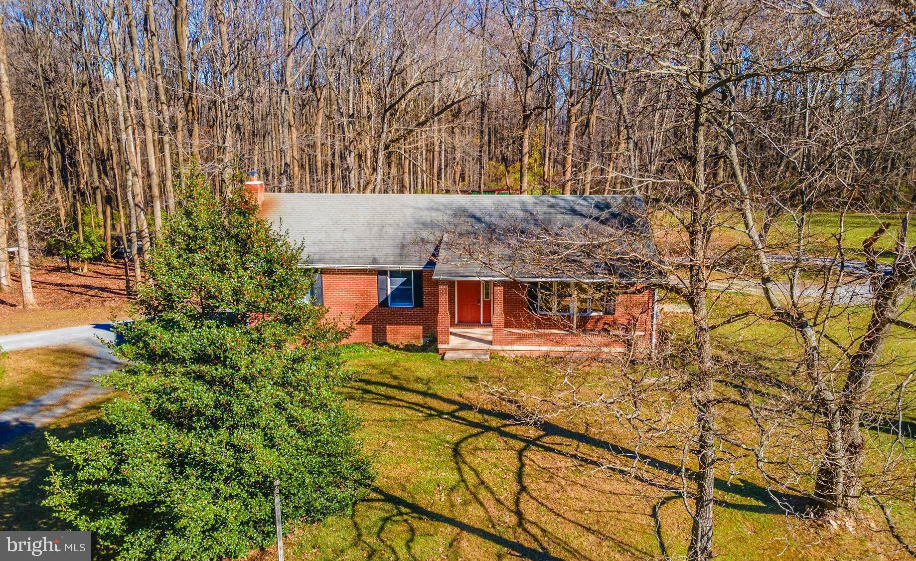 8009 Edgewood Church Road Frederick, MD 21702 - Photo 1 of 42 an aerial view of a house with swimming pool and large trees