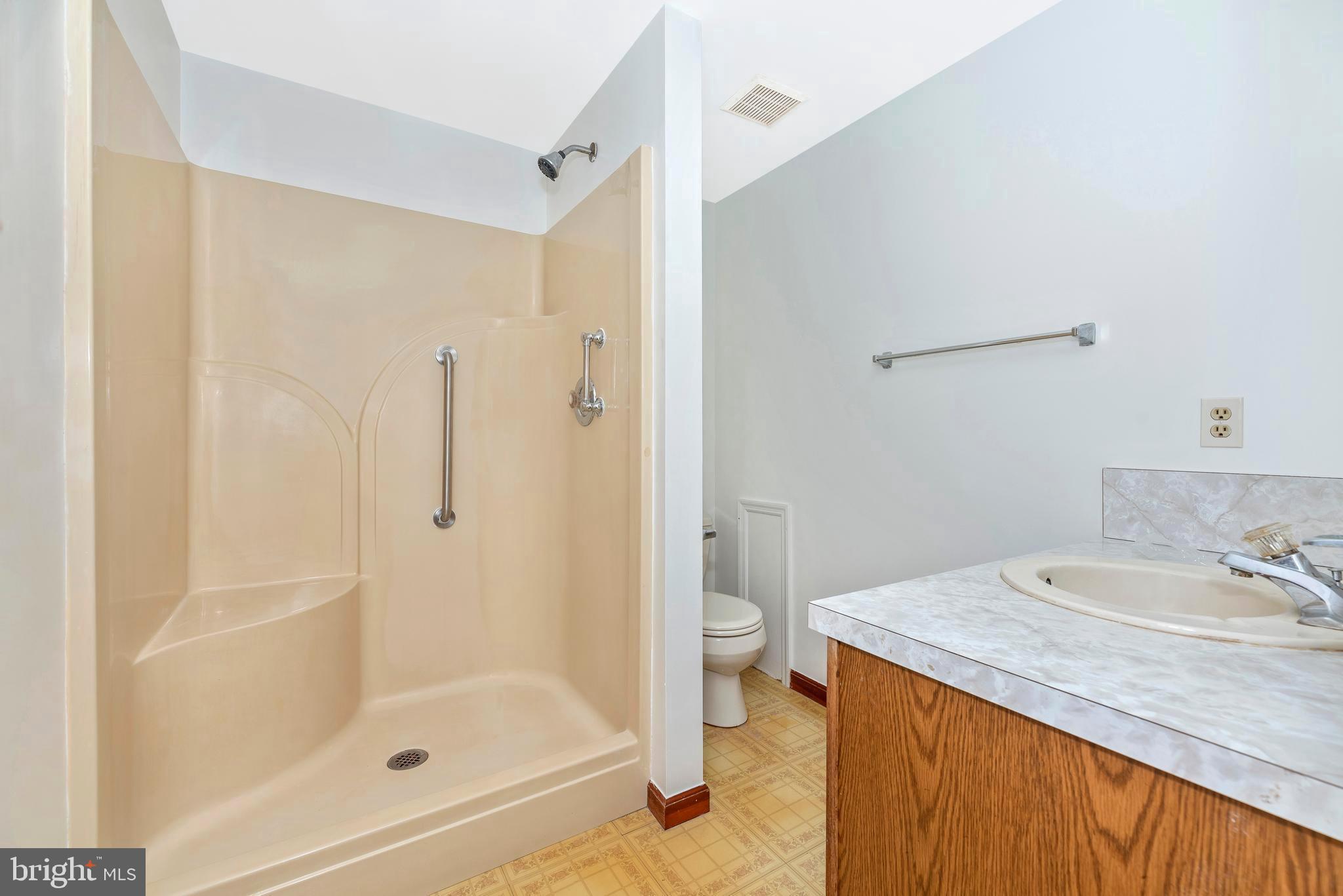 8009 Edgewood Church Road Frederick, MD 21702 - Photo 12 of 42 a bathroom with a granite countertop sink mirror and a bathtub