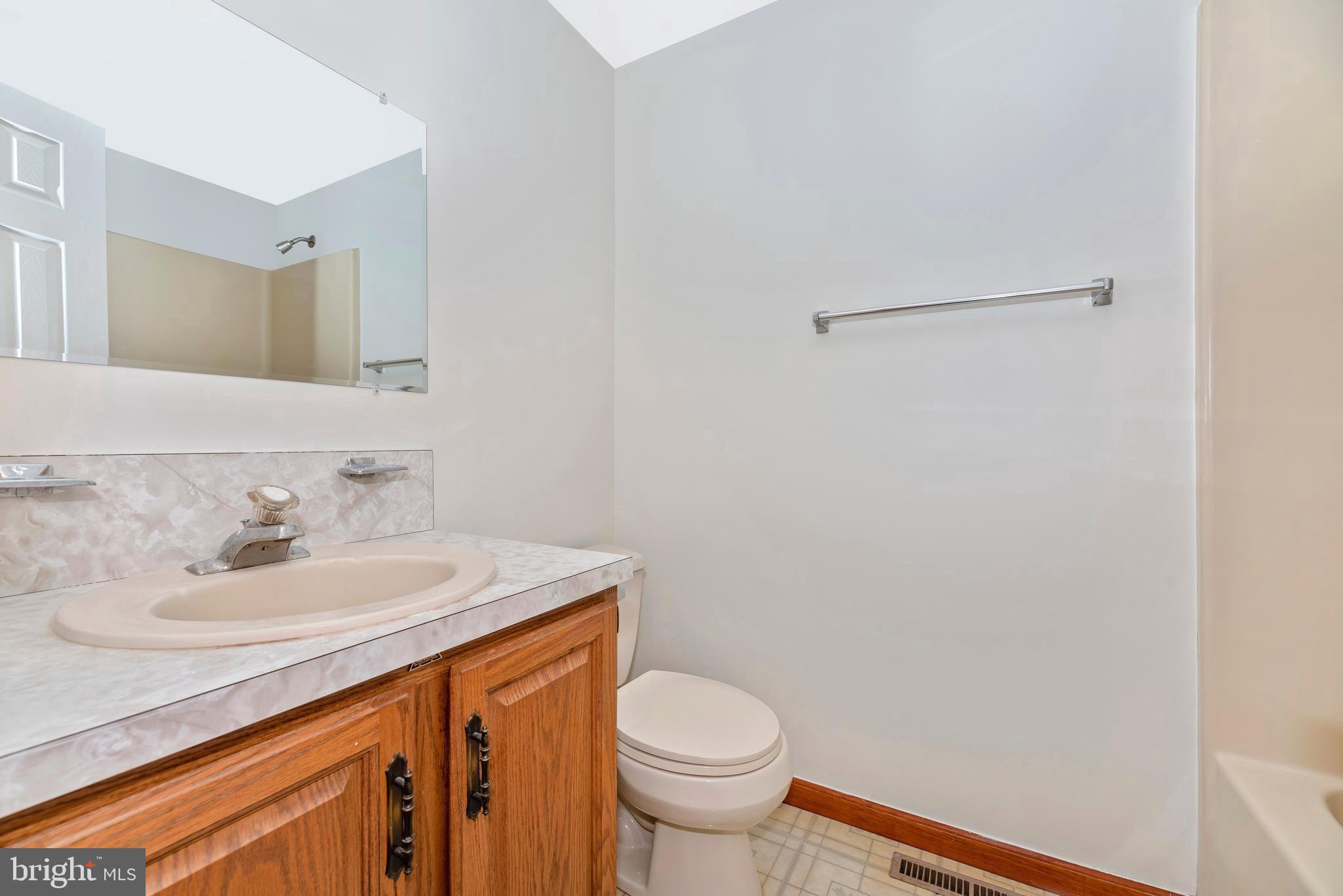 8009 Edgewood Church Road Frederick, MD 21702 - Photo 14 of 42 a bathroom with a sink toilet and a mirror