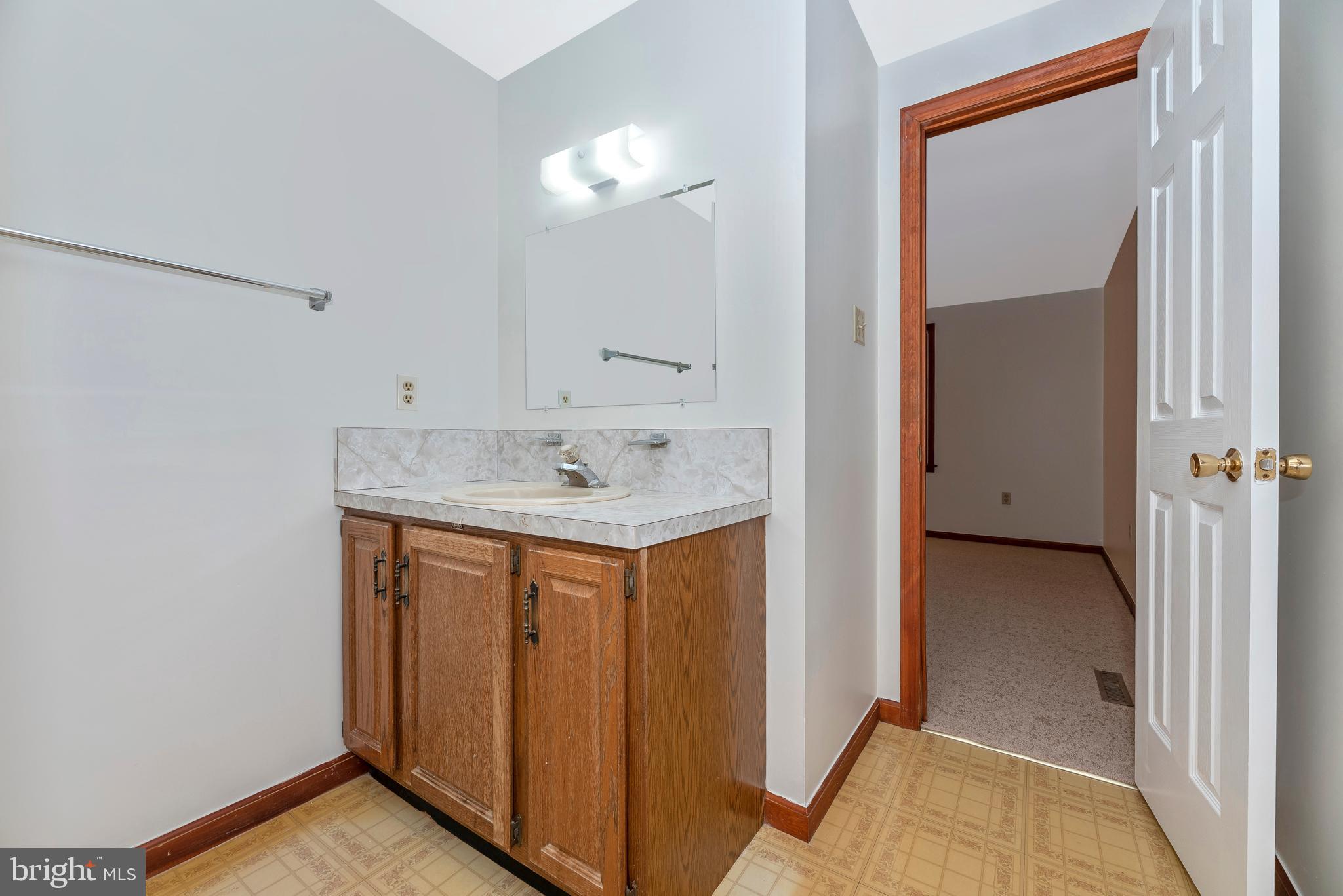 8009 Edgewood Church Road Frederick, MD 21702 - Photo 36 of 42 a bathroom with a sink and a mirror