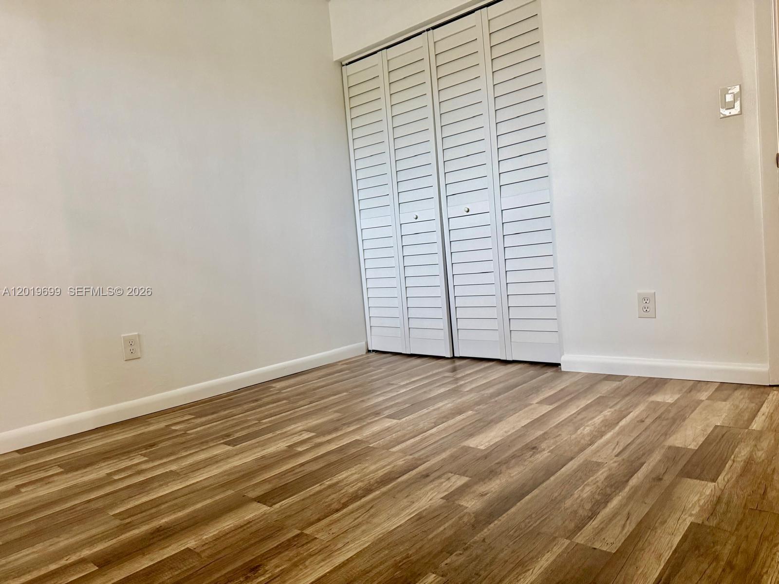 3470 Foxcroft Road, Unit 204 Miramar, FL 33025 - Photo 22 of 40 an empty room with wooden floor