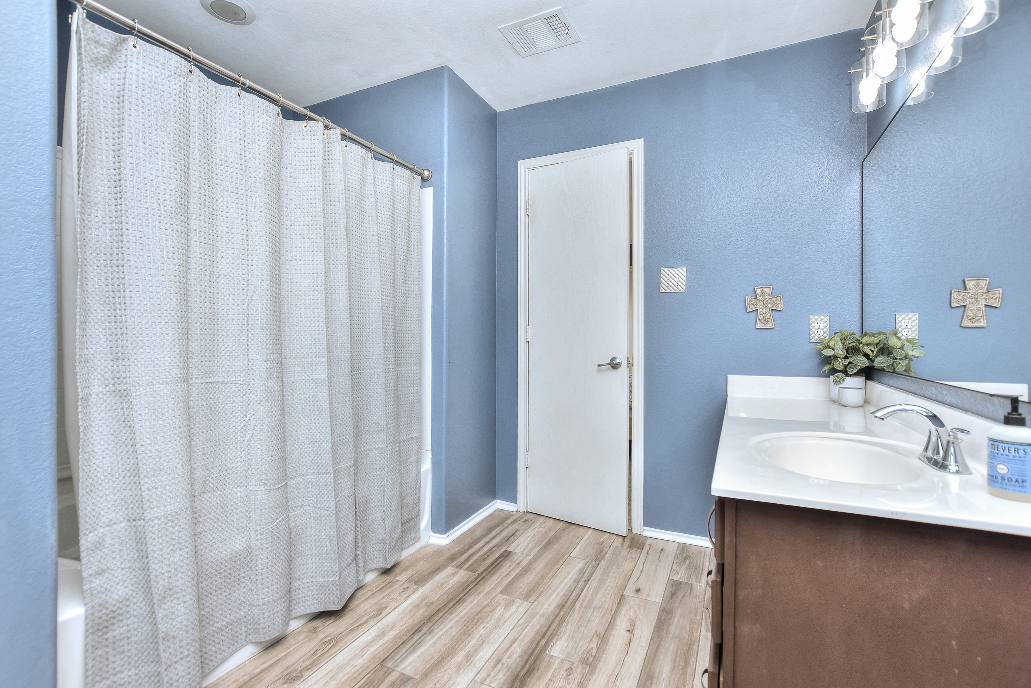 74 Jan Lane Georgetown, TX 78626 - Photo 27 of 31 a bathroom with a sink a mirror and a shower curtain