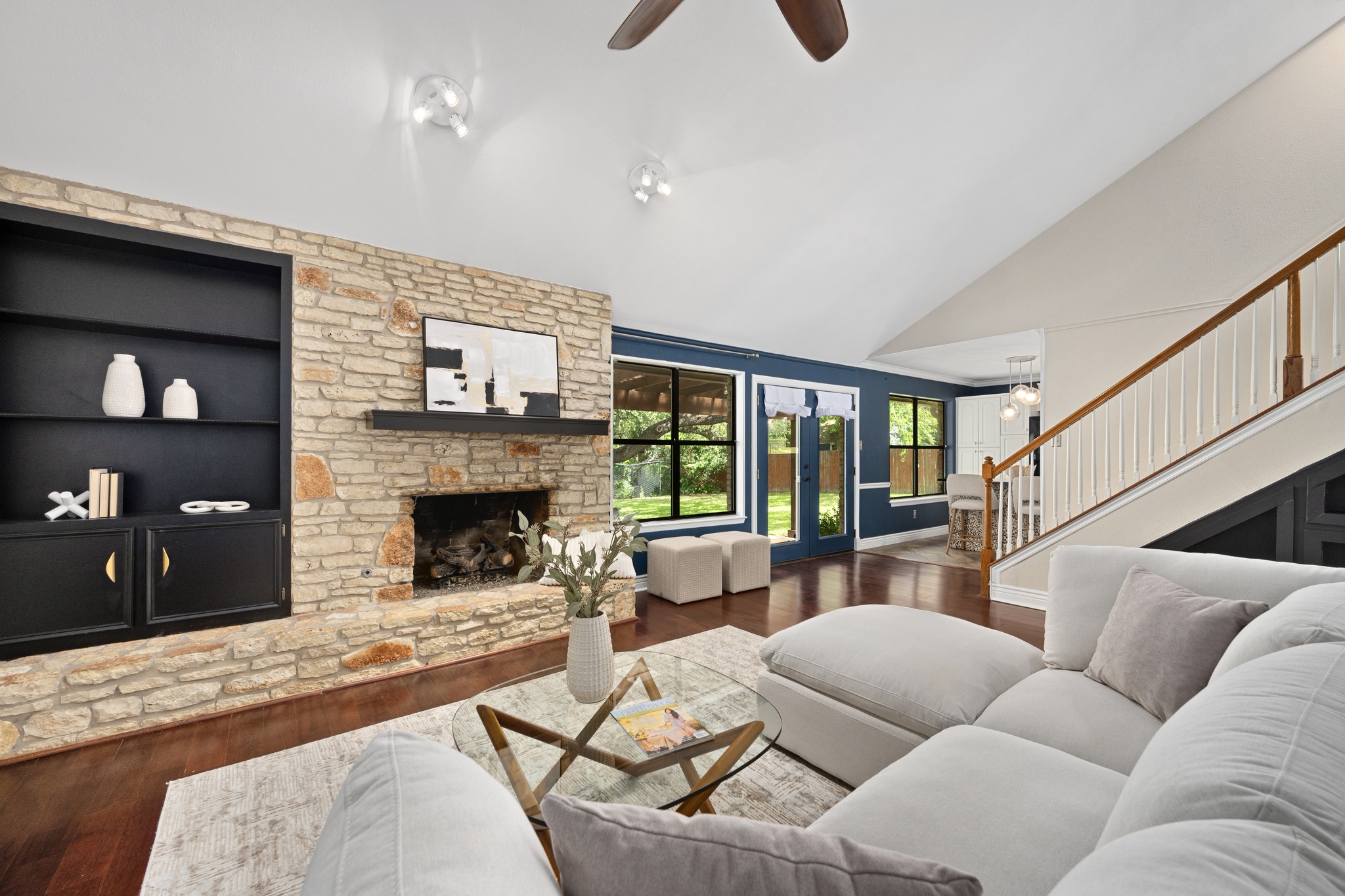 3908 Valley View Round Rock, TX 78681 - Photo 9 of 39 A closer look at the stone fireplace, built-in shelving, and those big windows that keep the backyard feeling part of the room.