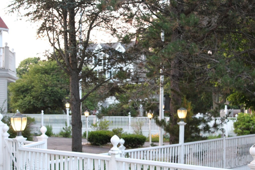 145 Puritan Road Swampscott, MA 01907 - Photo 8 of 19 a view of a house with large trees and wooden fence