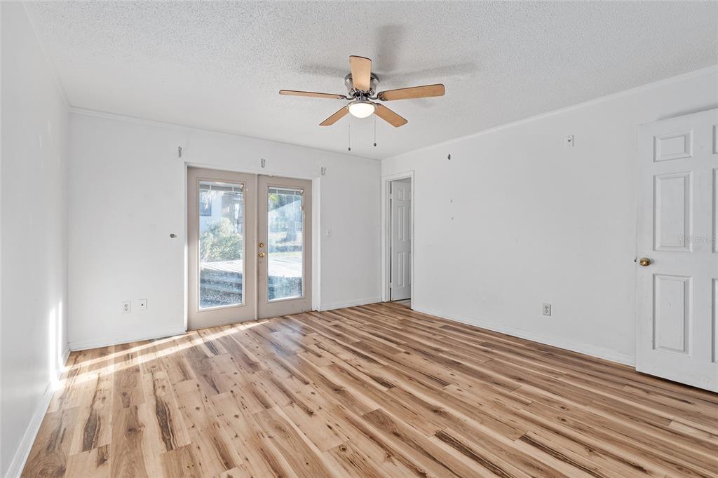 10577 Southeast 101st Avenue Road Belleview, FL 34420 - Photo 12 of 17 a view of empty room with wooden floor and fan