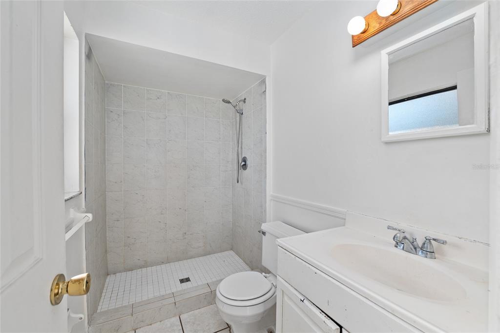10577 Southeast 101st Avenue Road Belleview, FL 34420 - Photo 13 of 17 a bathroom with a sink a toilet and shower