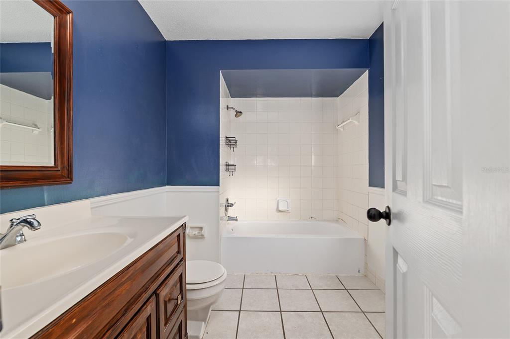 10577 Southeast 101st Avenue Road Belleview, FL 34420 - Photo 17 of 17 a bathroom with a sink a toilet and shower