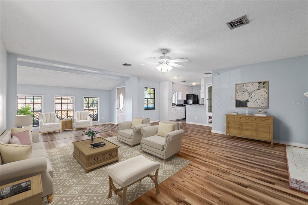 10577 Southeast 101st Avenue Road Belleview, FL 34420 - Photo 5 of 17 a living room with furniture or couch and a wooden floor