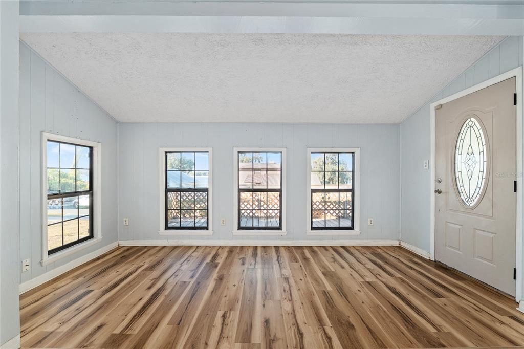 10577 Southeast 101st Avenue Road Belleview, FL 34420 - Photo 8 of 17 a view of an empty room with window and wooden floor