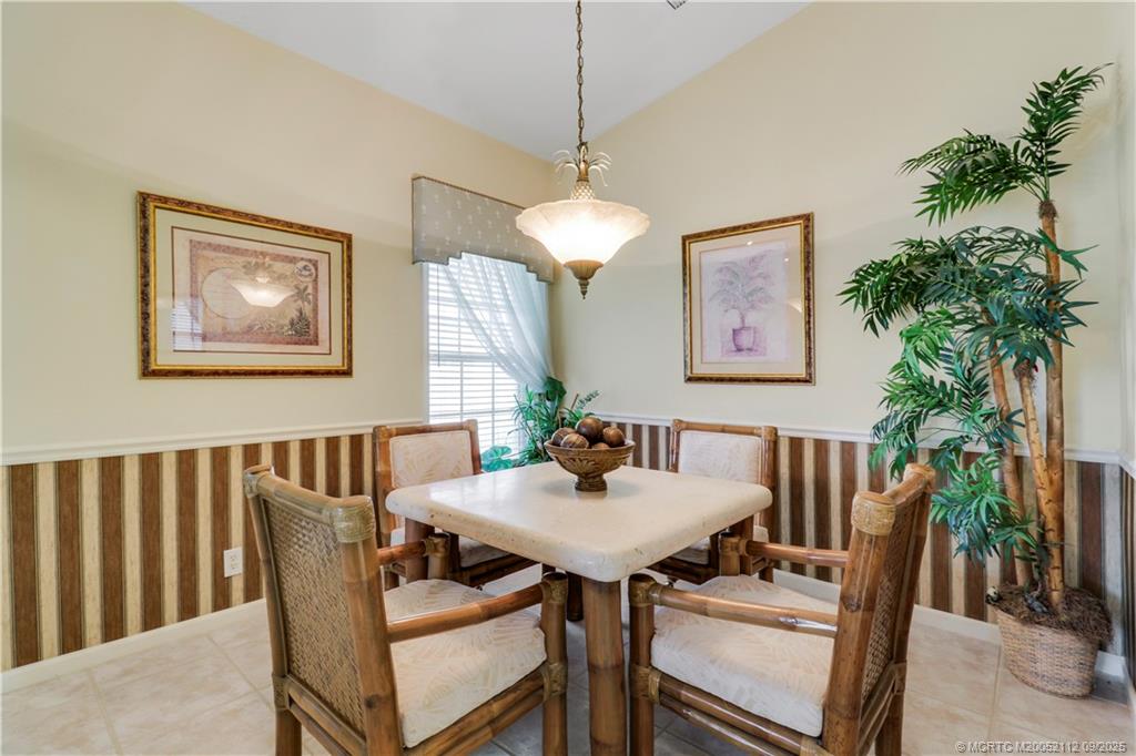 2698 Southwest Versailles Terrace Stuart, FL 34997 - Photo 13 of 29 a view of a dining room with furniture window and wooden floor