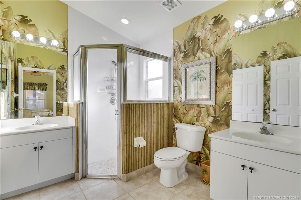 2698 Southwest Versailles Terrace Stuart, FL 34997 - Photo 21 of 29 a bathroom with a toilet sink and mirror