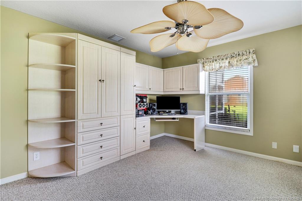 2698 Southwest Versailles Terrace Stuart, FL 34997 - Photo 23 of 29 a kitchen with a refrigerator and a ceiling fan