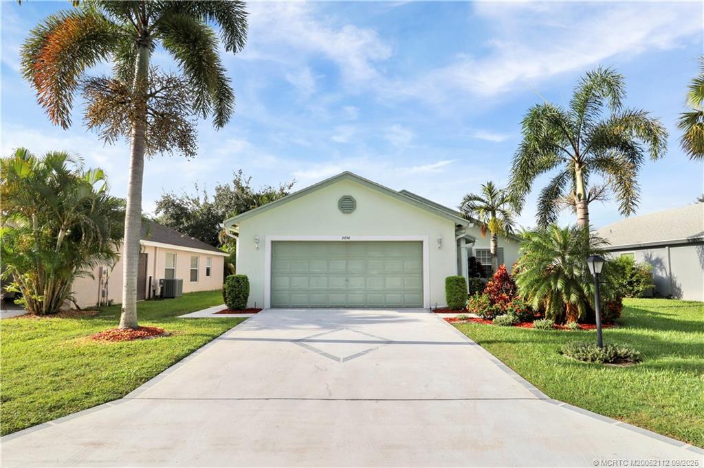 2698 Southwest Versailles Terrace Stuart, FL 34997 - Photo 3 of 29 a front view of house with yard and green space