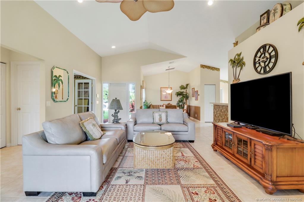 2698 Southwest Versailles Terrace Stuart, FL 34997 - Photo 5 of 29 a living room with furniture and a flat screen tv