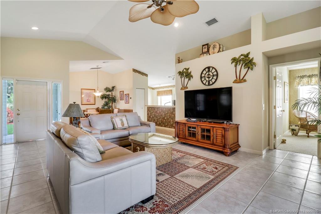 2698 Southwest Versailles Terrace Stuart, FL 34997 - Photo 6 of 29 a living room with furniture and a flat screen tv