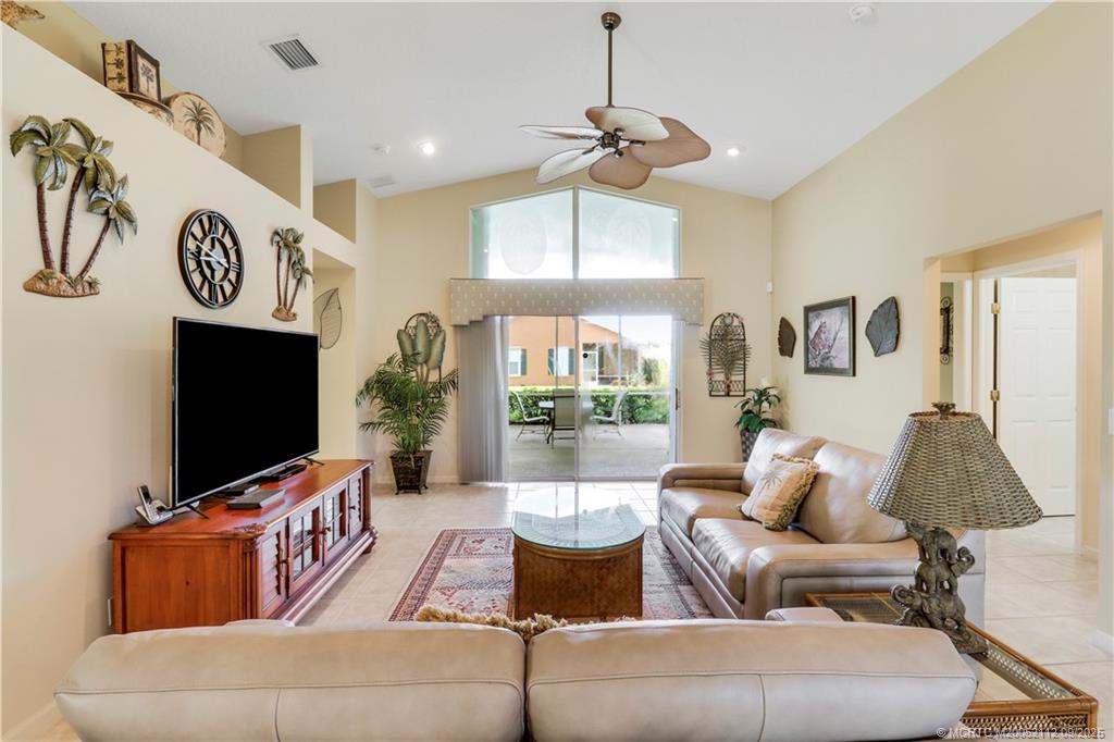 2698 Southwest Versailles Terrace Stuart, FL 34997 - Photo 7 of 29 a living room with furniture and a flat screen tv