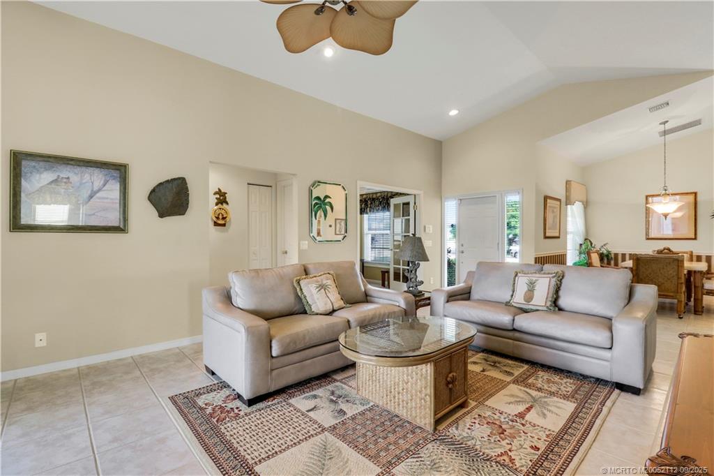 2698 Southwest Versailles Terrace Stuart, FL 34997 - Photo 9 of 29 a living room with furniture and a rug