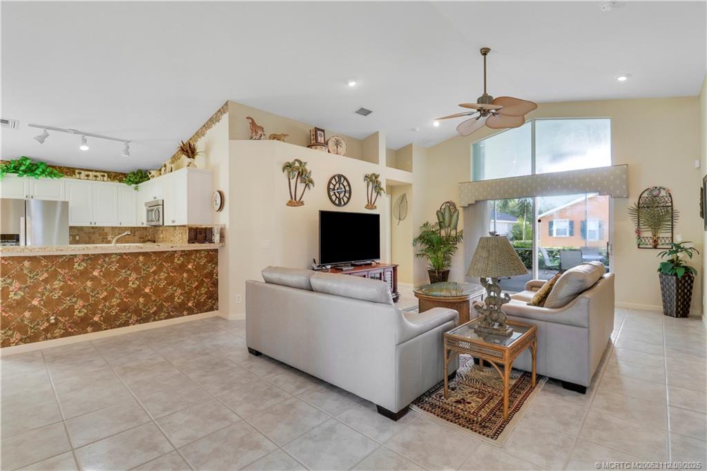 2698 Southwest Versailles Terrace Stuart, FL 34997 - Photo 10 of 29 a living room with furniture and a fireplace