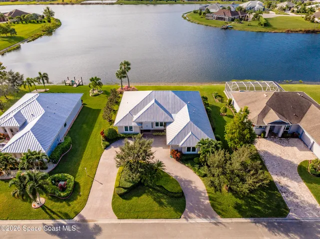 an aerial view of a house with a swimming pool