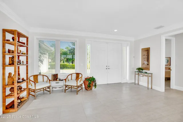 a view of a livingroom with furniture and floor to ceiling window