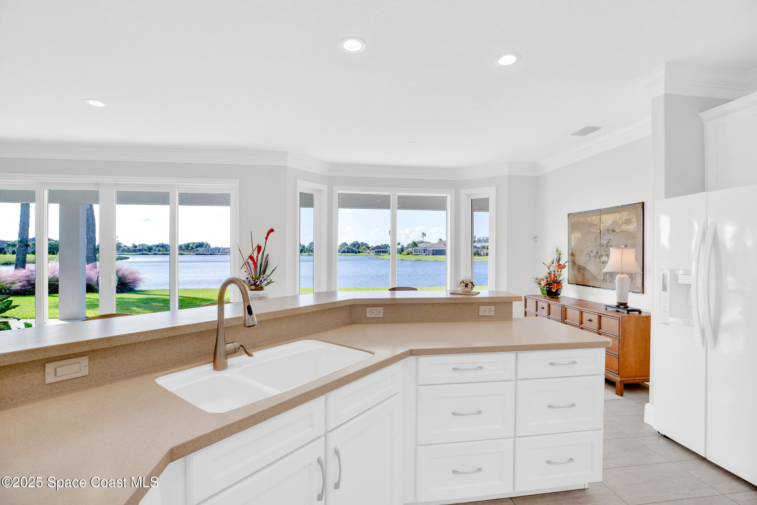 307 Yearling Trail Sebastian, FL 32958 - Photo 19 of 40 a kitchen with granite countertop a sink and a refrigerator