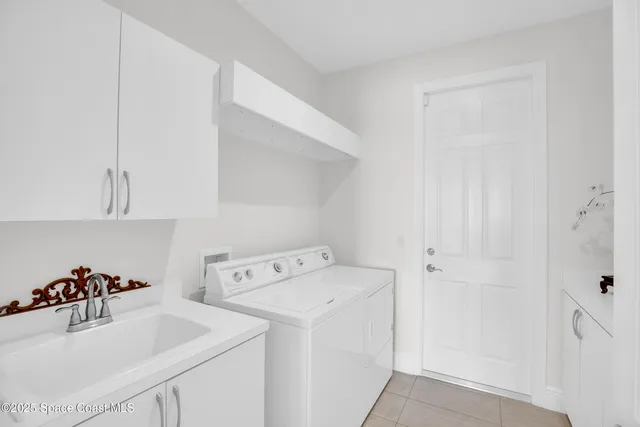 a utility room with sink dryer and washer