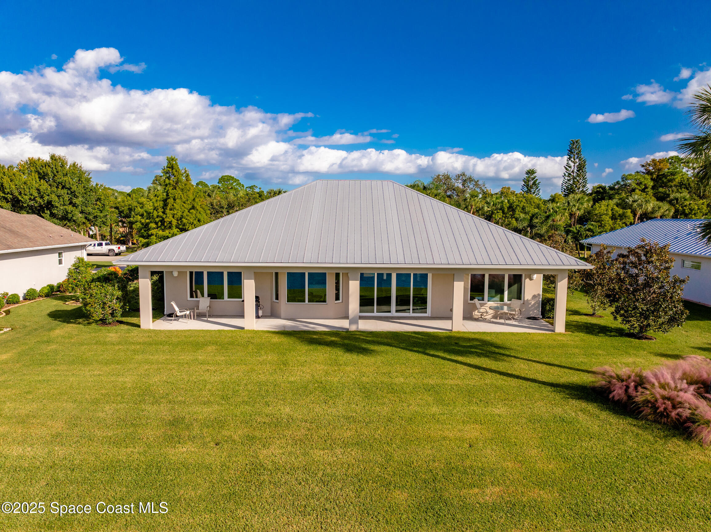 307 Yearling Trail Sebastian, FL 32958 - Photo 39 of 40 a front view of a house with swimming pool having outdoor seating