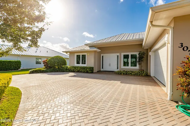 a view of a white house with a yard