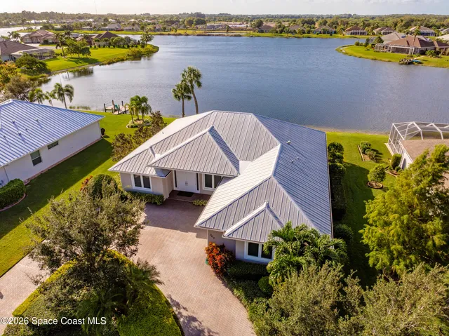 an aerial view of a house with a lake view