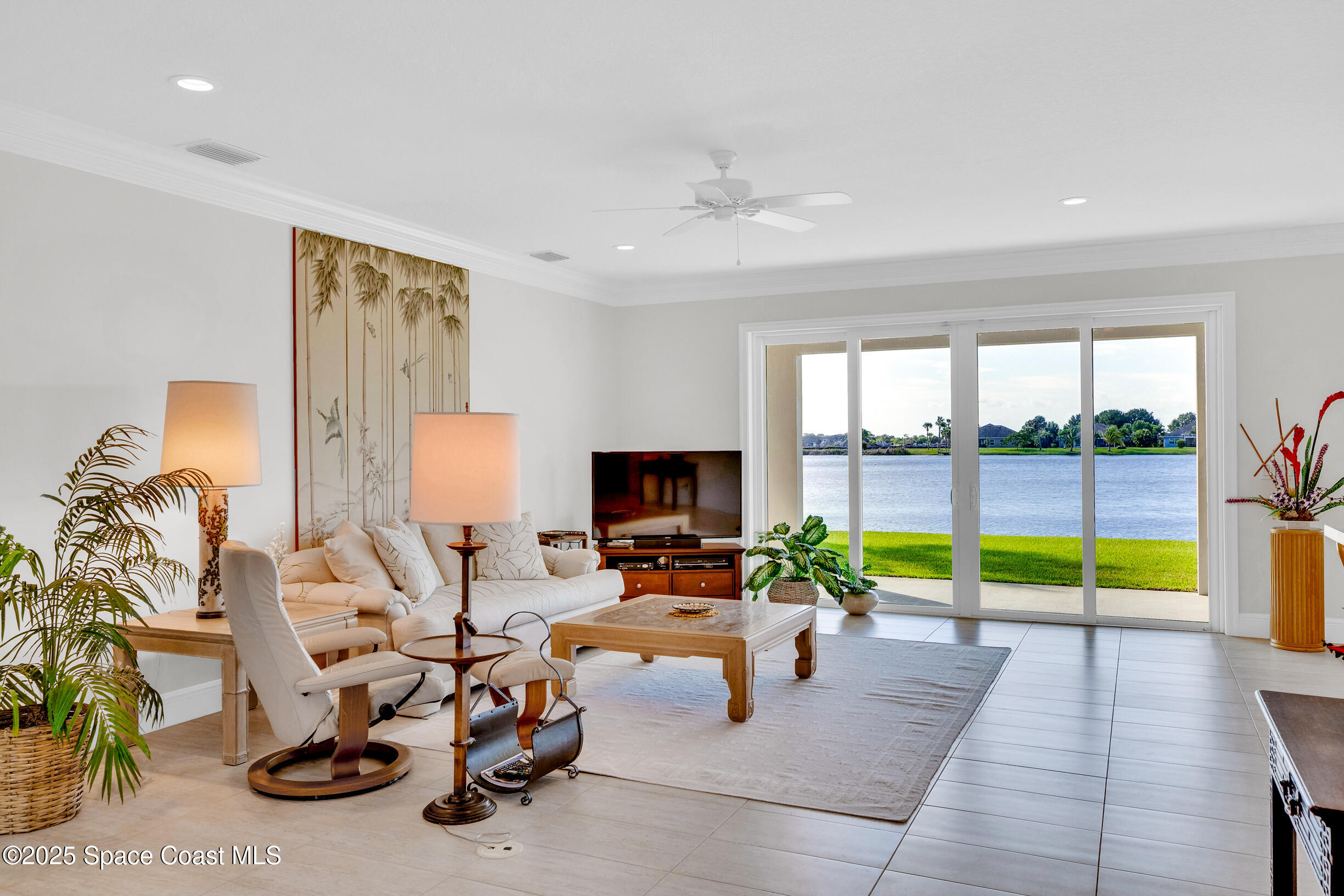 307 Yearling Trail Sebastian, FL 32958 - Photo 7 of 40 a living room with furniture and a floor to ceiling window